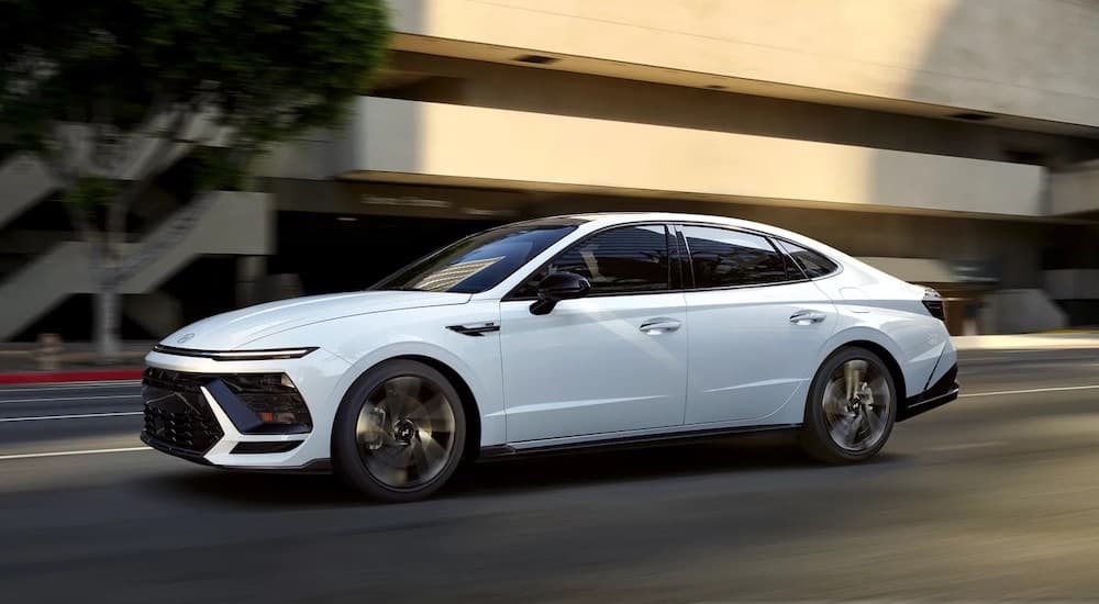 A white 2024 Hyundai Sonata N-Line is shown from the side after leaving a Hyundai dealer.