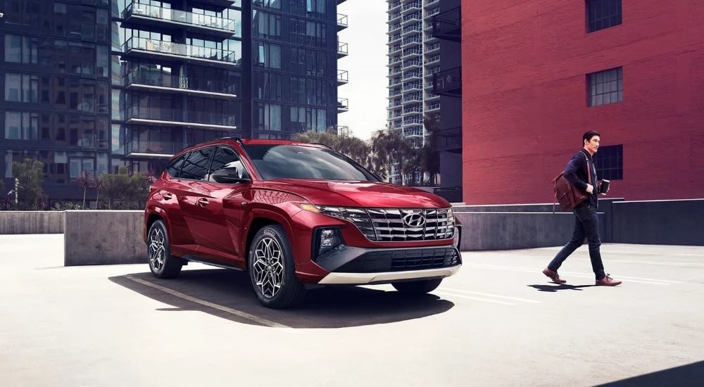 A red 2024 Hyundai Tucson N-Line parked in the city.