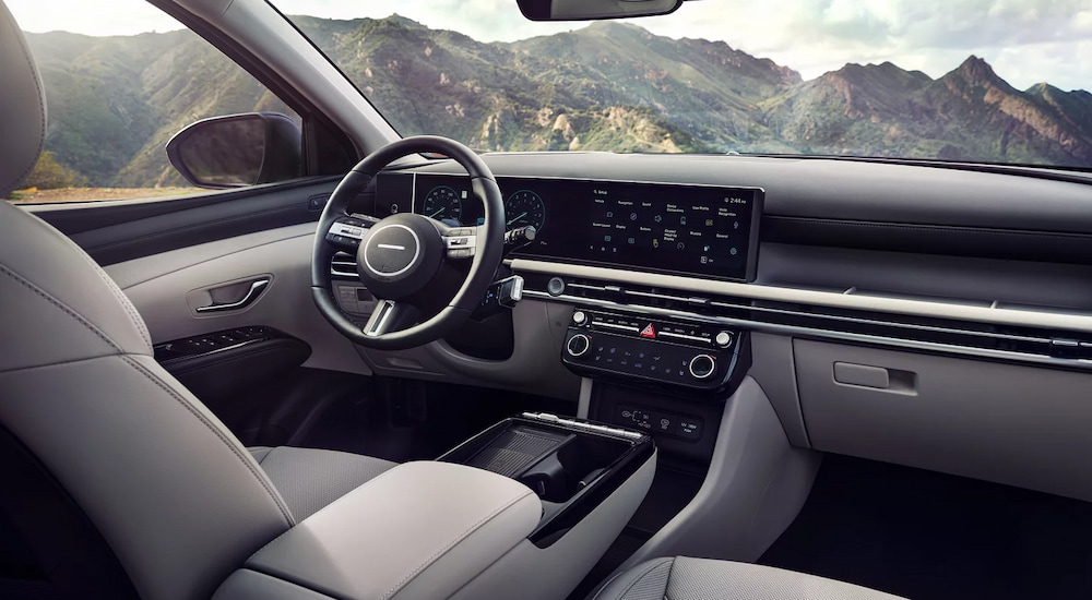 The steering wheel and infotainment screens in a 2025 Hyundai Tucson Limited at a Hyundai dealer near Powell.