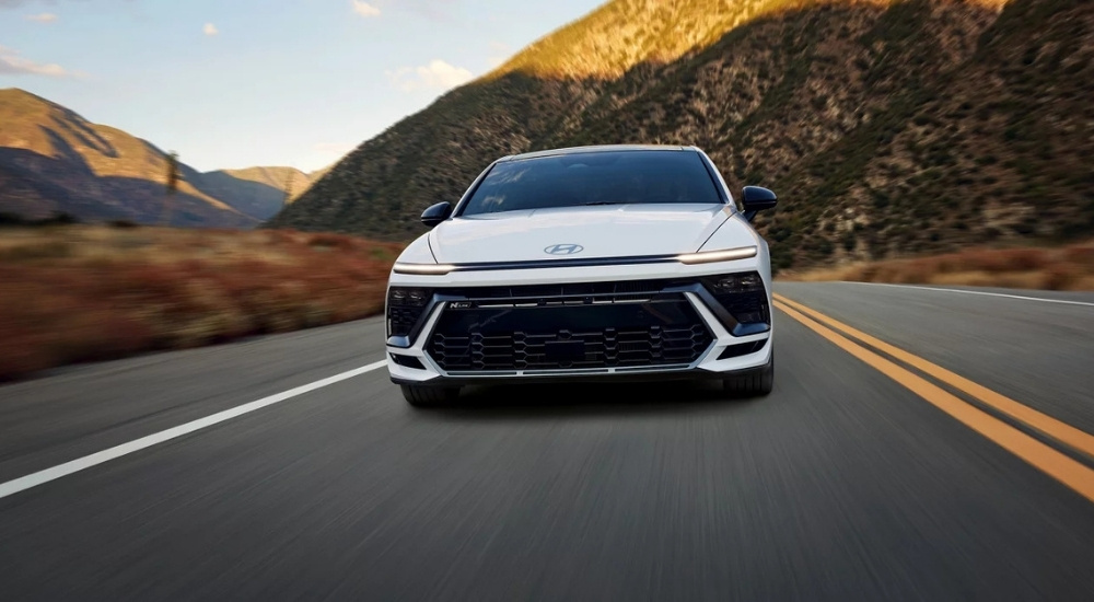 Head-on view of a white 2025 Hyundai Sonata N-Line driving to a Hyundai dealer near Norris.