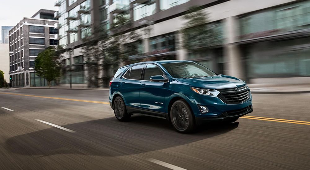 Blue 2021 Chevy Equinox driving on a city street