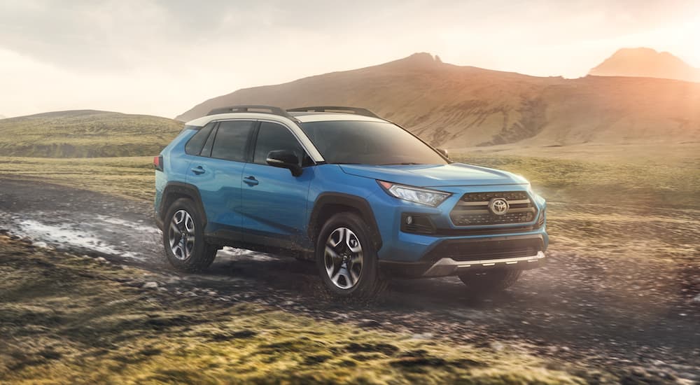 Blue 2020 Toyota RAV4 driving off-road.