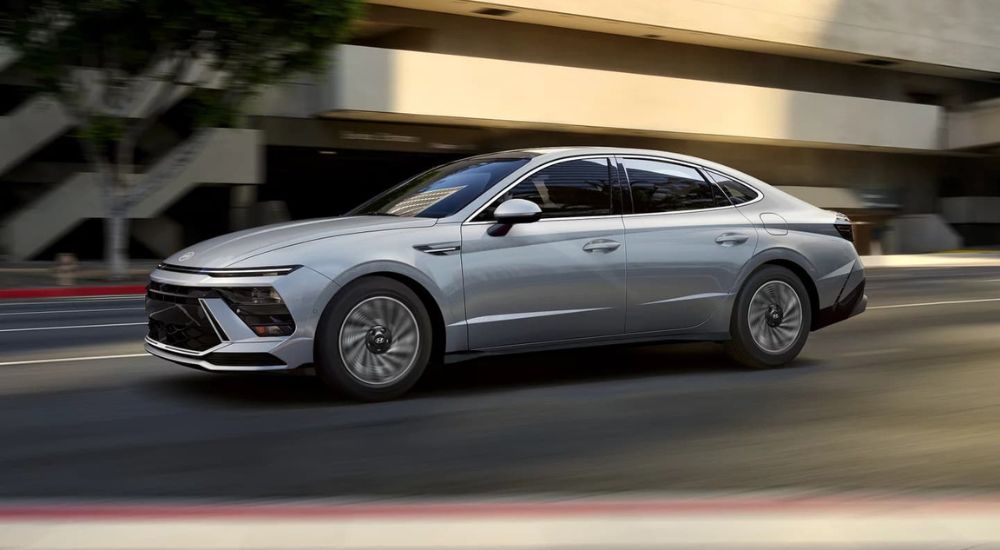 A silver 2024 Hyundai Sonata driving in a city.