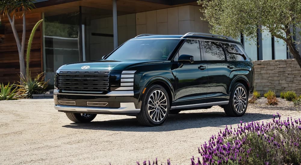 A blue 2026 Hyundai Palisade parked in a driveway