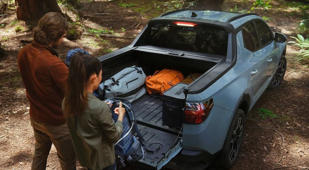 Gear in the bed of a blue 2026 Hyundai Santa Cruz.