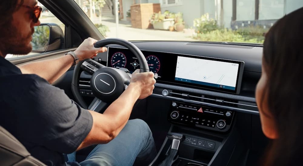 A person driving a 2026 Hyundai Santa Cruz.