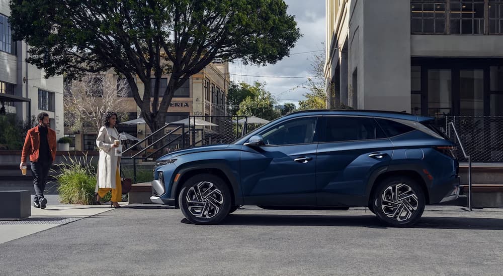 Blue 2026 Hyundai Tucson parked on the side of a city street
