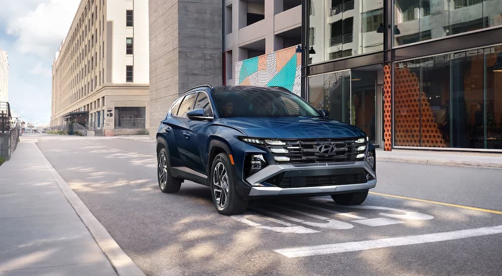 Blue 2026 Hyundai Tucson at a stoplight in a city