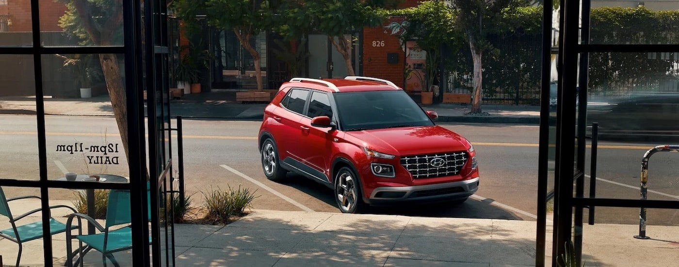 A red 2023 Hyundai Venue is shown from the front after leaving a Hyundai dealer near Oliver Springs.