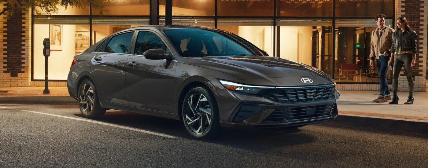 Grey 2026 Hyundai Elantra Hybrid Limited parked in front of a building
