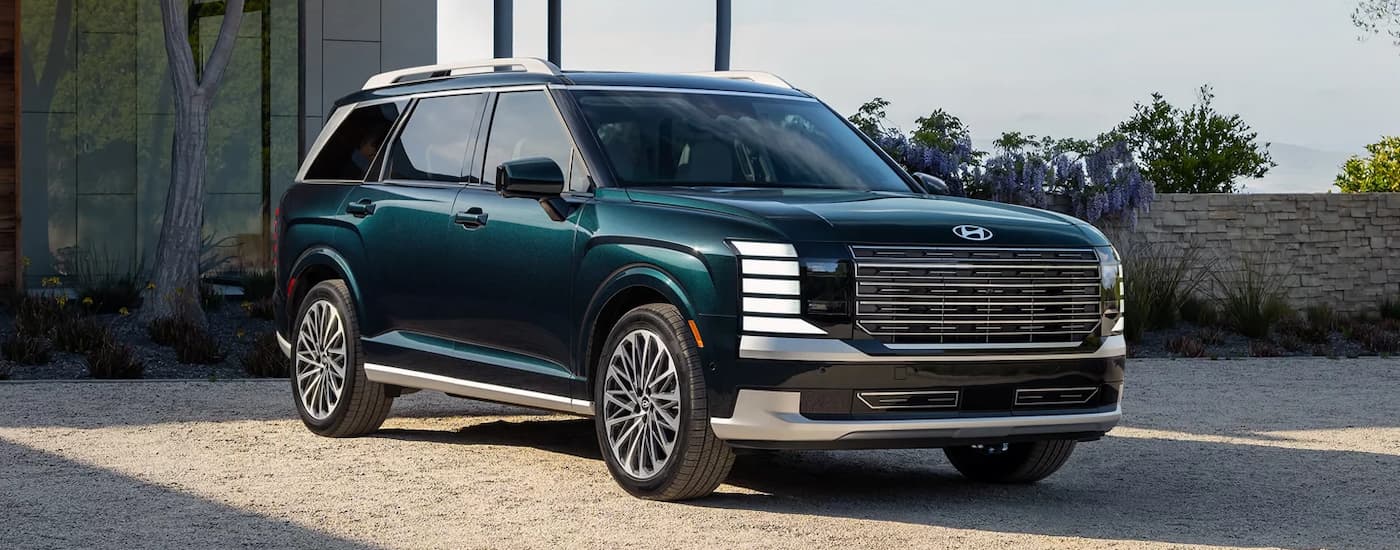 Green 2026 Hyundai Palisade parked in front of a house.