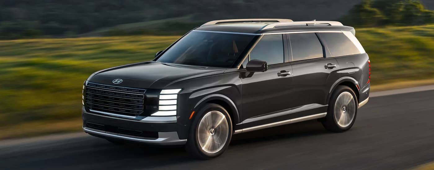 Black 2026 Hyundai Palisade driving on a highway
