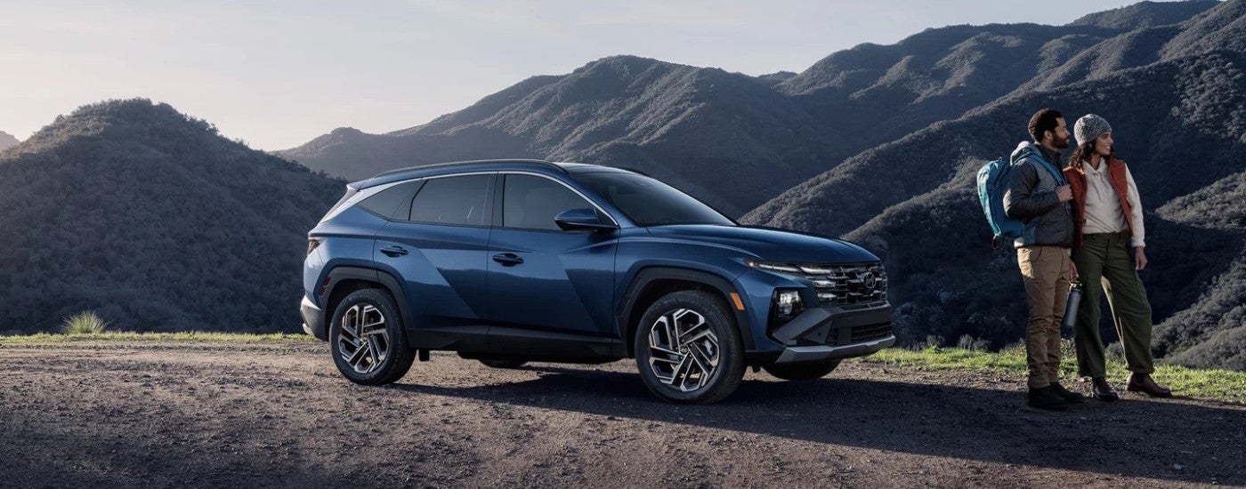 Hikers near a blue 2026 Hyundai Tucson Limited