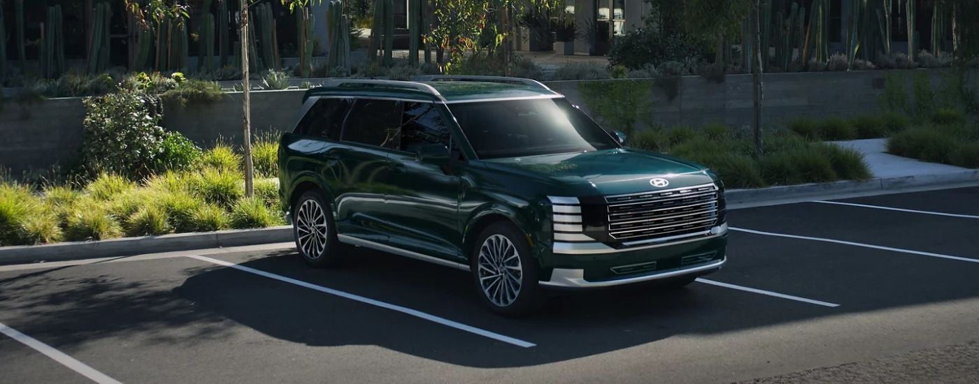 A green 2026 Hyundai Palisade Calligraphy parked.