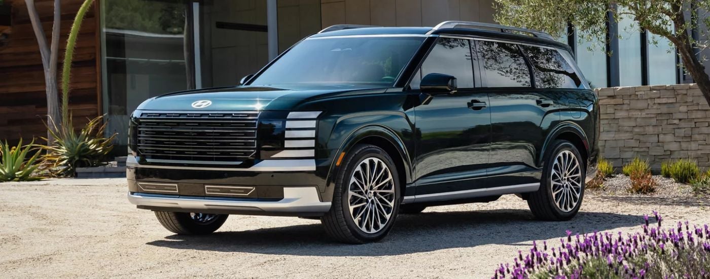 A green 2027 Hyundai Palisade Calligraphy parked in a driveway.