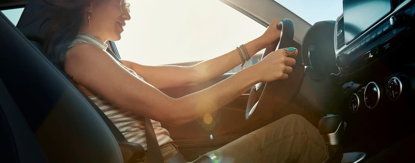 Woman test driving a 2025 Hyundai Venue at a Hyundai dealer near Morristown.