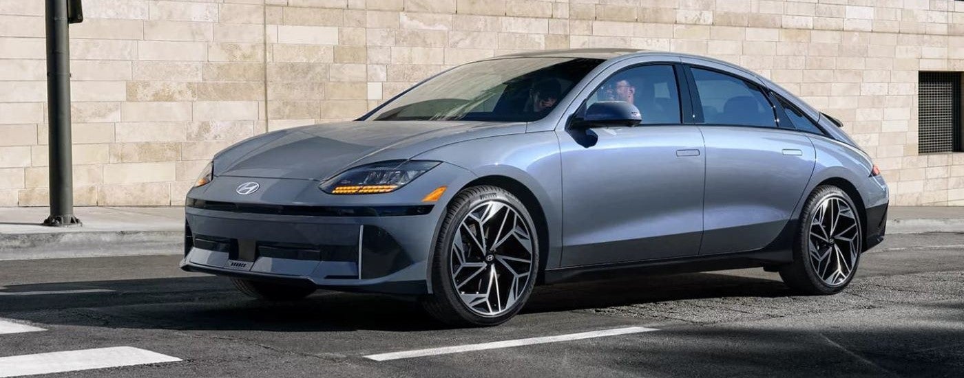 A silver 2023 Hyundai IONIQ 6 driving to a Hyundai dealer near Seymour.