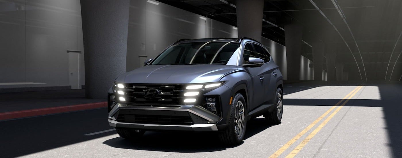 Grey 2026 Hyundai Tucson driving through a tunnel.